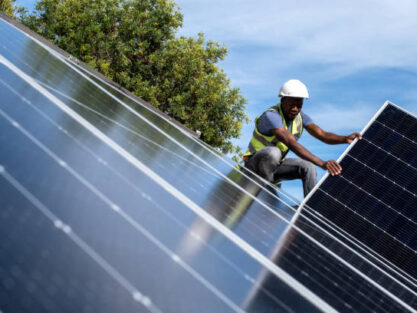 An African Engineer installing solar panels on the roof of a residential house in Cape Town, South Africa. Alternative energy solutions are critical during load shedding in South Africa